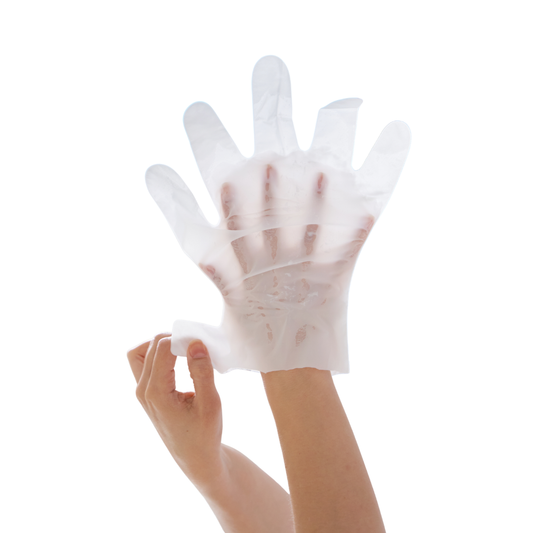 A translucent white disposable keratin moisturizing glove being worn on a hand against a plain white background.