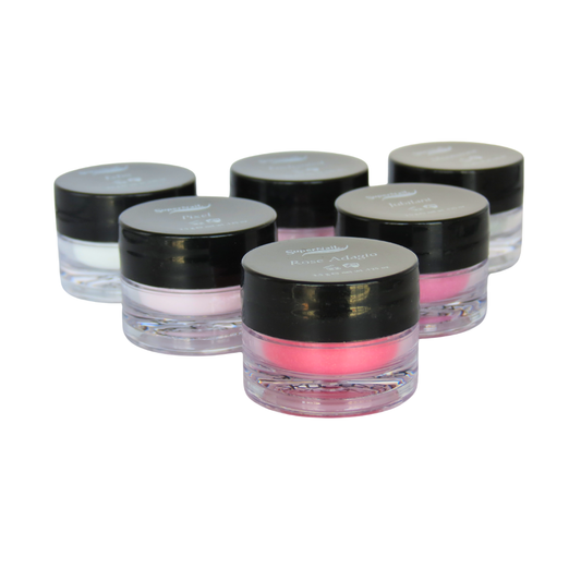 Five small cosmetic jars with black lids and clear bases, arranged in a cluster on a white background. The jars contain light pink, white, and bright pink acrylic powders, with one jar in the foreground showing a vivid pink product.