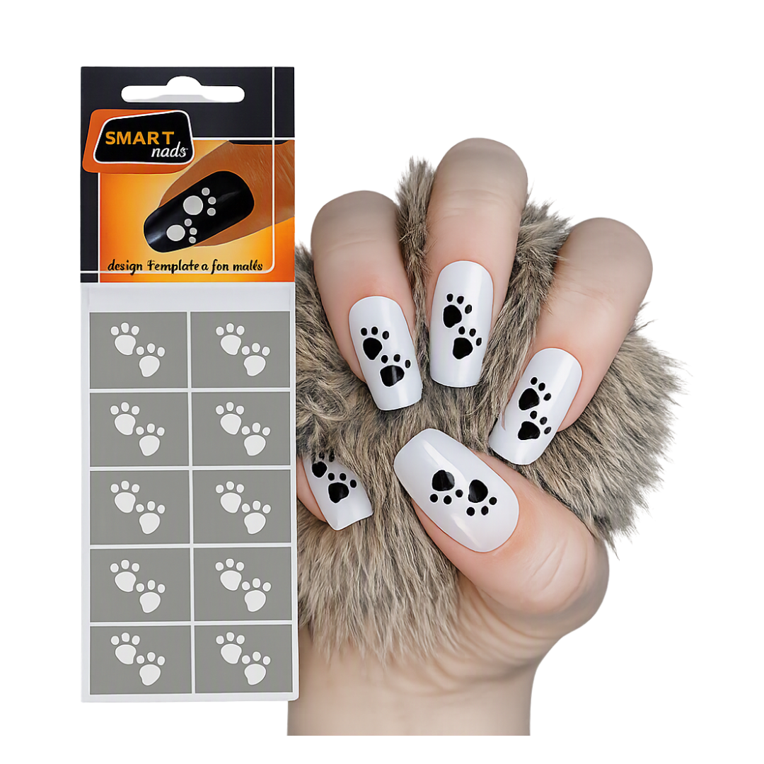 A hand with glossy white nails decorated with black paw shapes, shown next to the retail package for SMART nails star design templates on a white background.