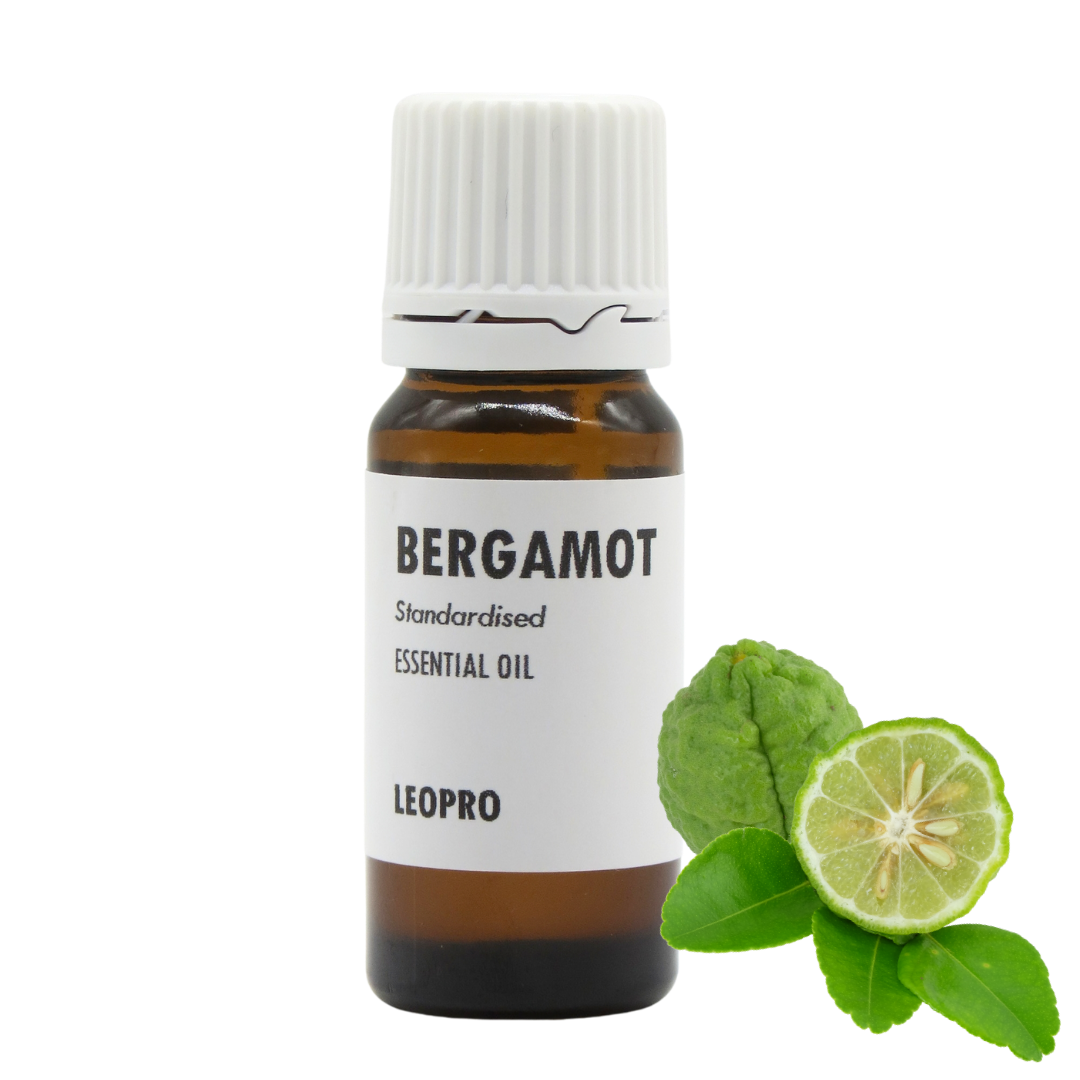 A bottle of LEOPRO Bergamot Standardised Essential Oil next to fresh bergamot citrus slices and green leaves, on a solid white background.