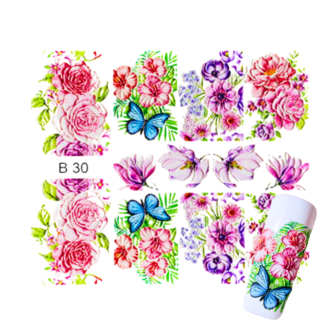 Nail art sticker sheet featuring pink and purple floral designs, green leaves, and blue butterflies, shown alongside a white roll of matching floral nail stickers on a plain white background.