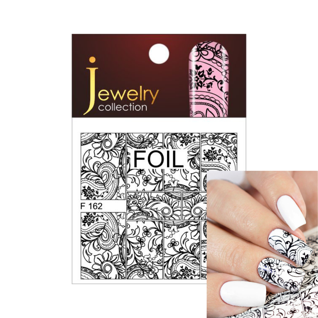 Jewelry collection foil nail art set, featuring black and white ornate scrollwork designs on a white card with a dark red header, shown alongside a hand displaying the applied black and white nail pattern over white base nails.