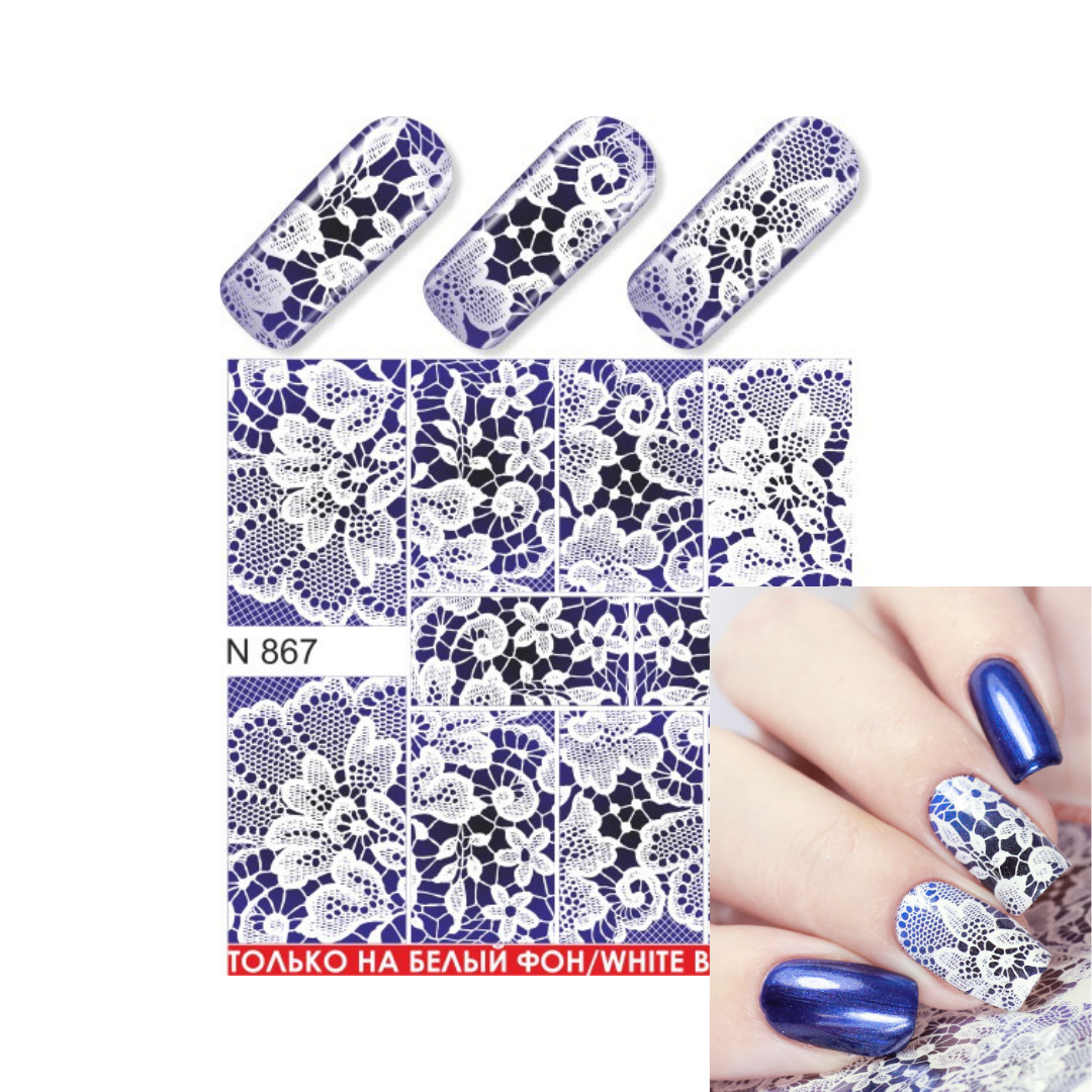 Nail art water slider sheet with blue and white floral lace pattern, shown with three sample nail tips and a hand displaying the applied blue-and-white nail design.