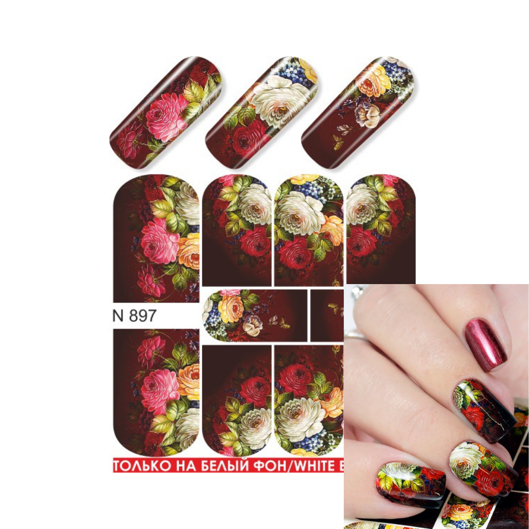 Nail art decal sheet with floral designs, shown with sample nail tips and a hand demonstrating the applied design. The decals feature red, pink, white, yellow, and blue flowers on a dark background.