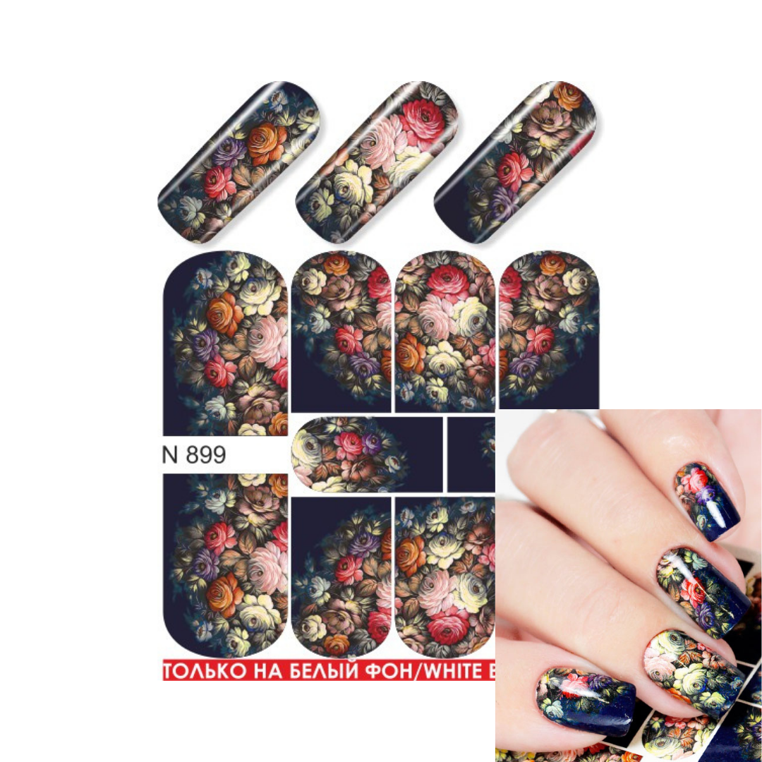 Nail art sticker sheet with floral nail wrap designs shown on sample nail tips and a hand, featuring multicolor flowers on a dark background. Text reads 'N 899' and 'ТОЛЬКО НА БЕЛЫЙ ФОН / WHITE ONLY'.