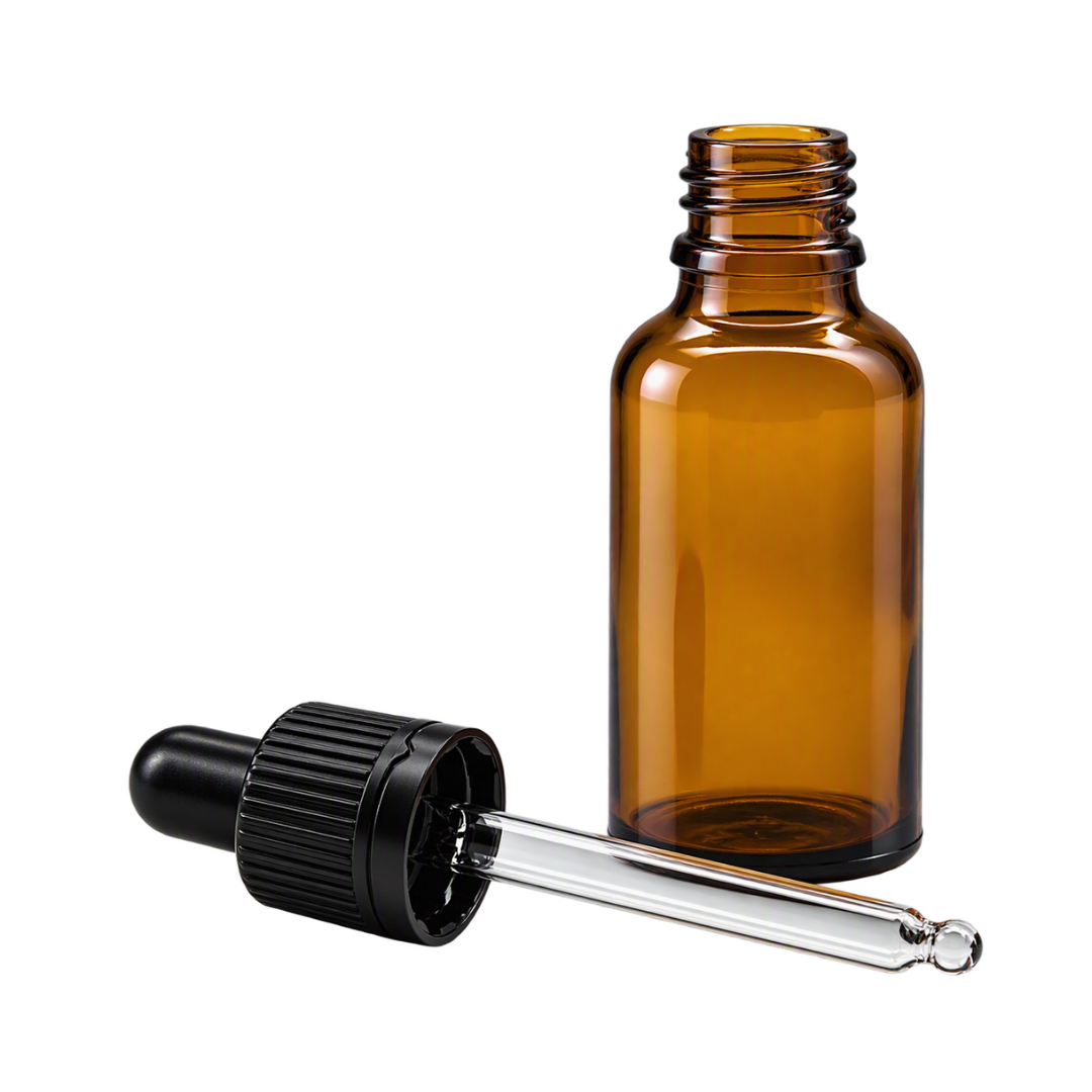 An empty 30ml amber glass dropper bottle shown next to its detached black rubber bulb and clear glass pipette on a white background.
