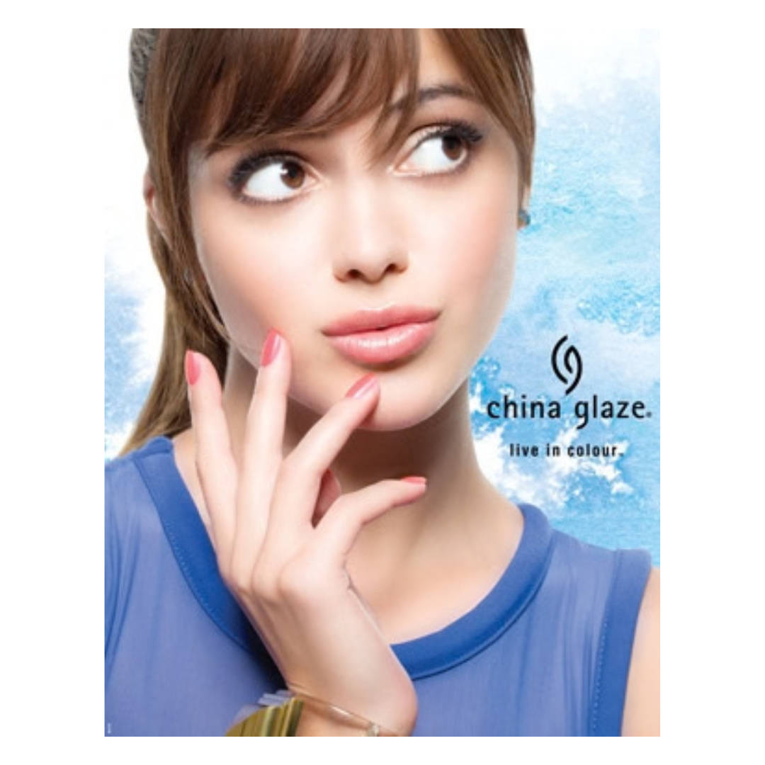 A close-up portrait of a woman with brown hair and bangs, wearing a blue sleeveless top, with the text 'china glaze. live in colour.