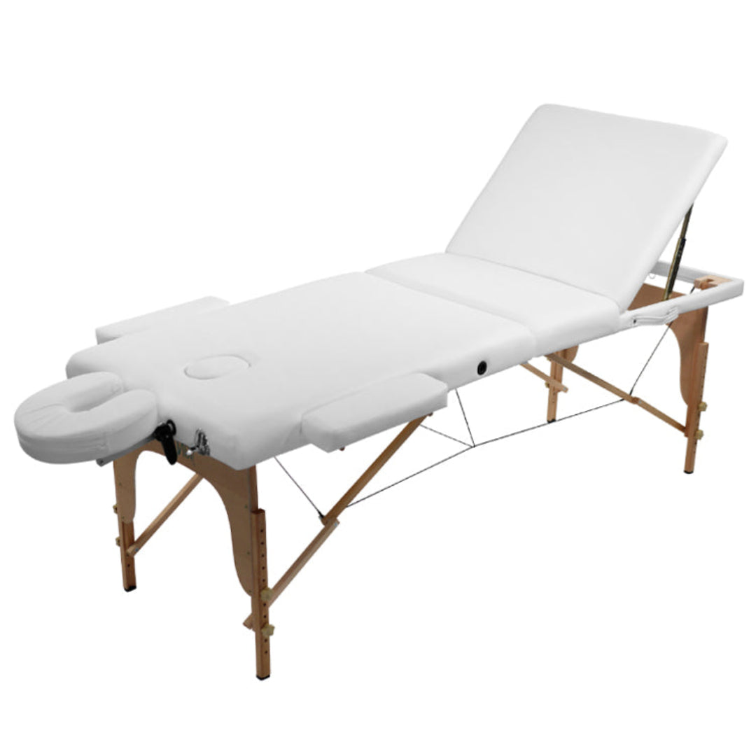 A portable white PVC massage table with a wooden frame, adjustable headrest, armrests, and a breathing hole in the bed as well as a u-shaped attachment.