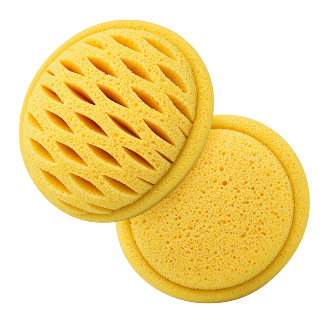 Two yellow body wash sponges with different textures, one showing a slotted pattern and the other showing a solid porous surface, on a white background.