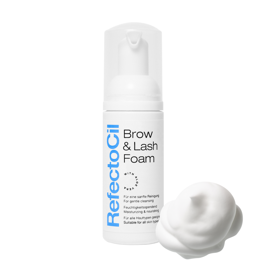 A white pump bottle of RefectoCil Brow & Lash Foam with blue text, shown next to a dollop of white foam on a solid white background.
