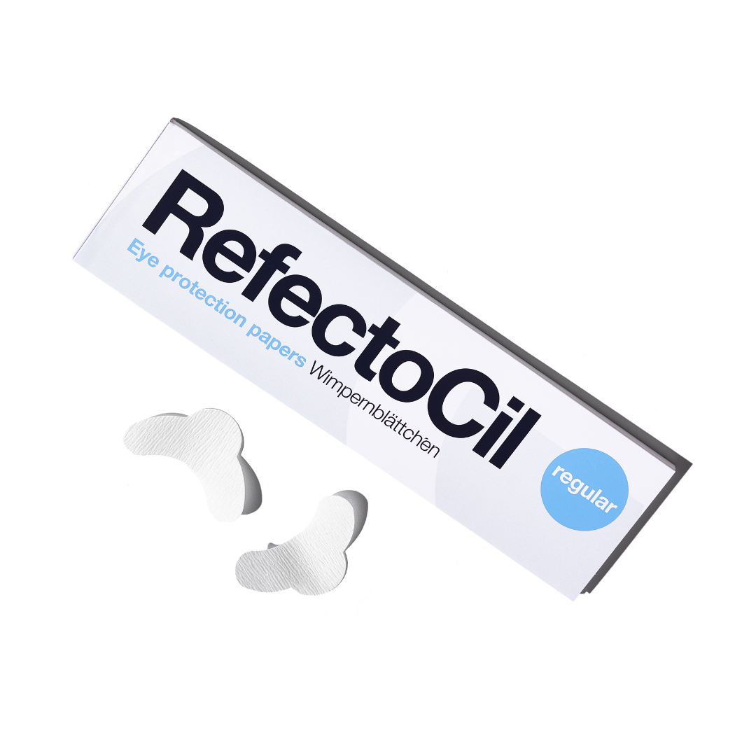 A booklet of RefectoCil regular eye protection papers with two white tear-shaped eye patches placed in front, on a clean white background.