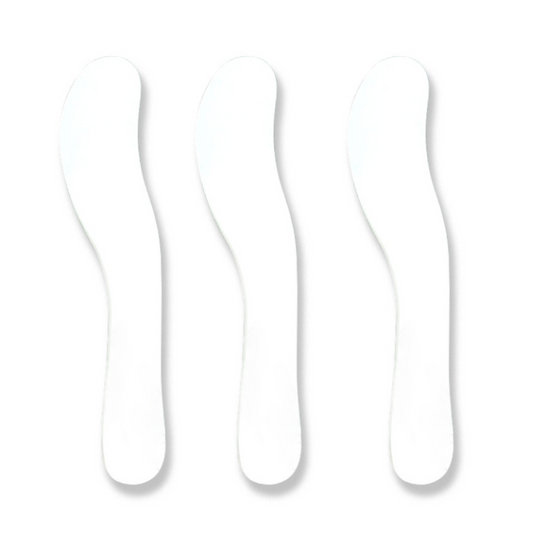 Five white curved plastic spatulas arranged in a row on a plain background.