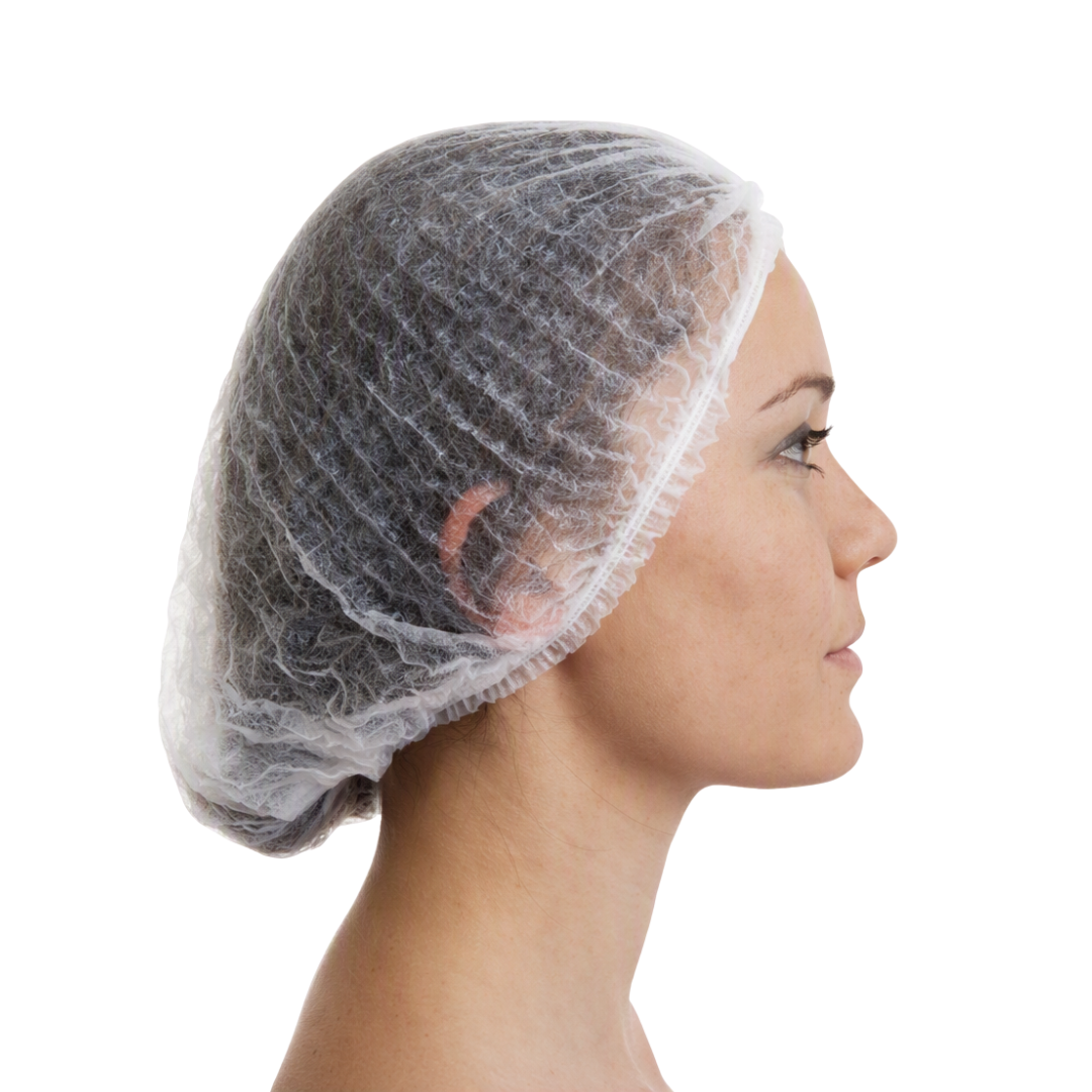 A side profile of a woman wearing a disposable, semi-transparent white hairnet against a solid white background.