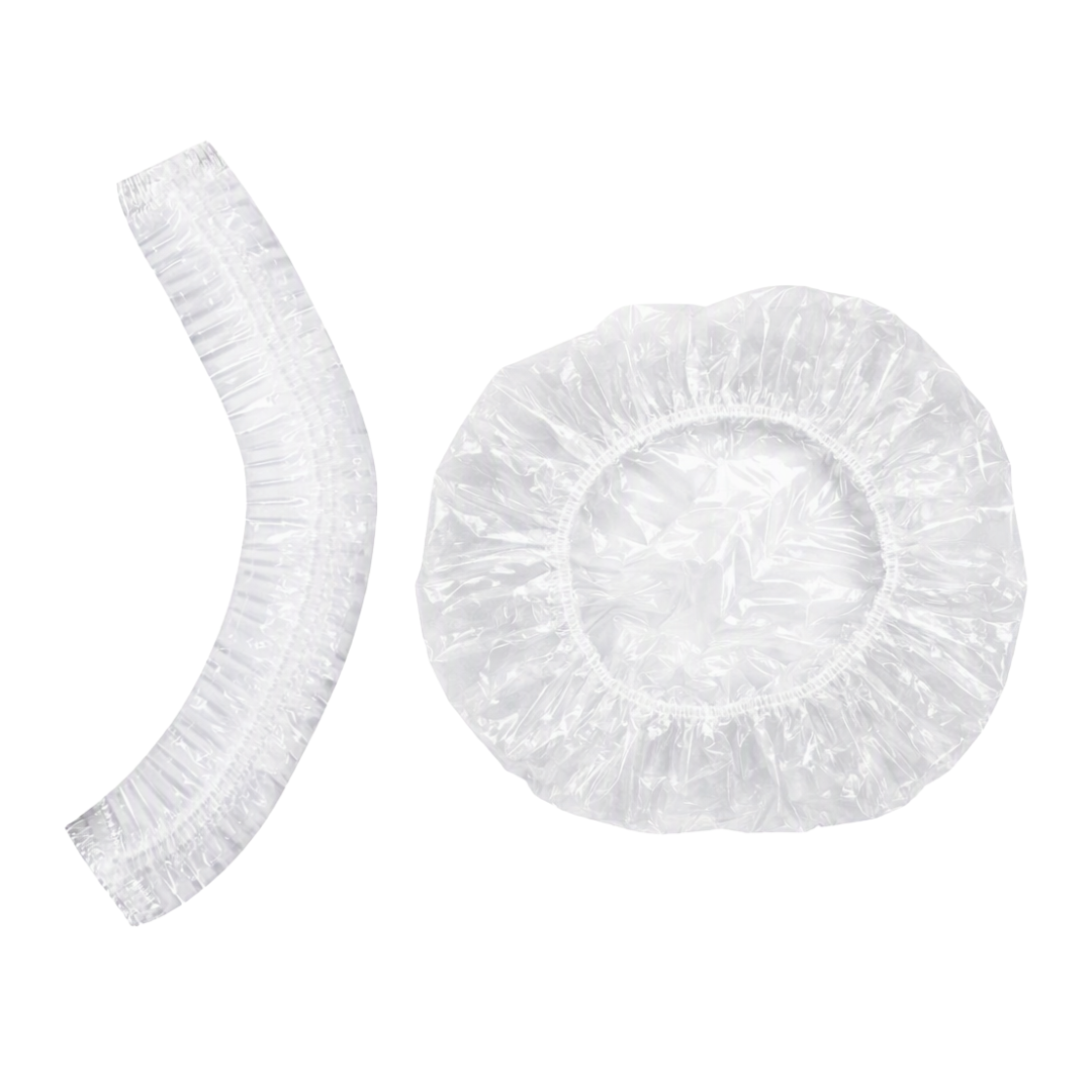 Clear plastic shower cap in "closed" for and in open form next to it on white background