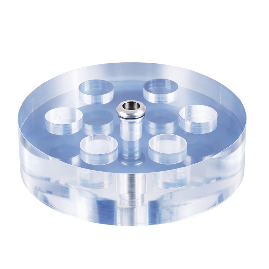 A clear acrylic circular pigment ink and pen holder with multiple circular wells and a central metal pin, shown on a plain white background.