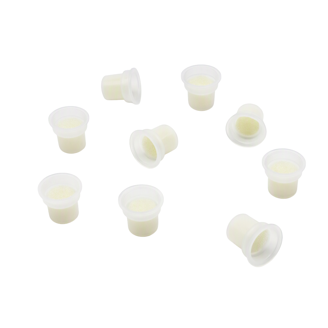 Nine small translucent white plastic pigment mixing pots arranged on a plain white background.