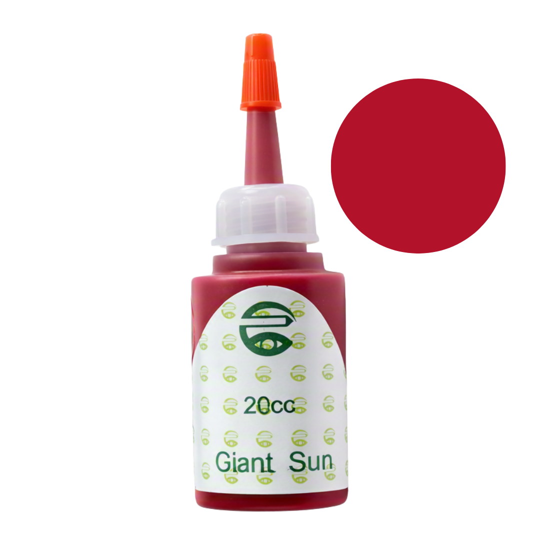 A 20cc bottle of Giant Sun red pigment permanent makeup ink with an orange cap and a white label, shown next to a solid red color swatch on a white background.
