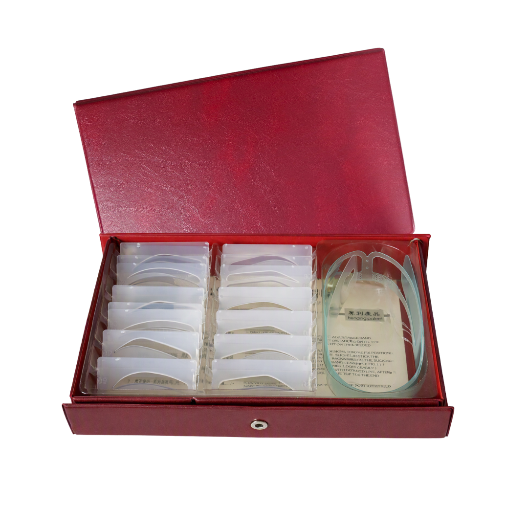An open red presentation box containing multiple small white plastic eyebrow shaping stencils arranged in rows, with a clear plastic head strap and printed paper insert on the right side, photographed on a plain white background.
