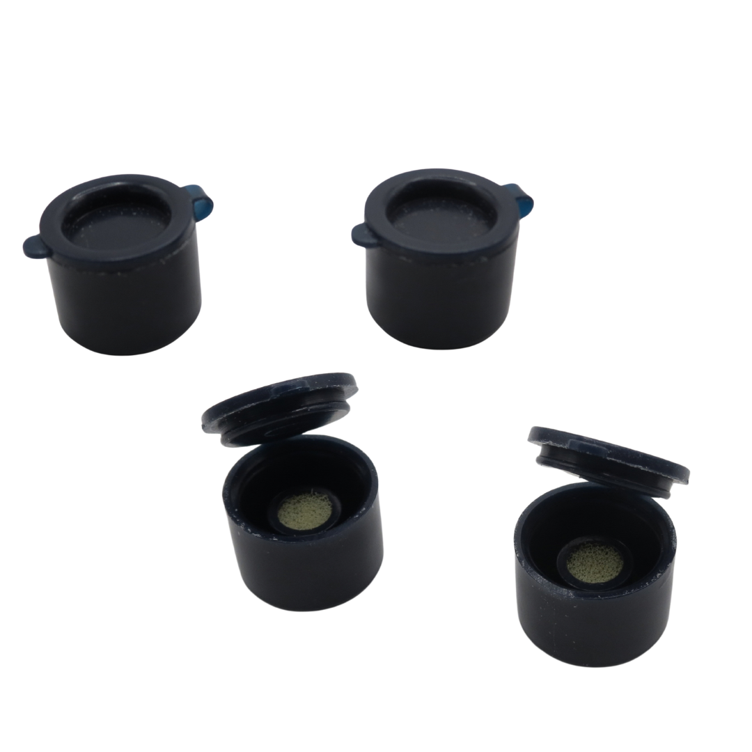 Four small dark blue pigment mixing pots, with two closed and two open showing a light-colored filter or mesh insert inside, on a plain white background.