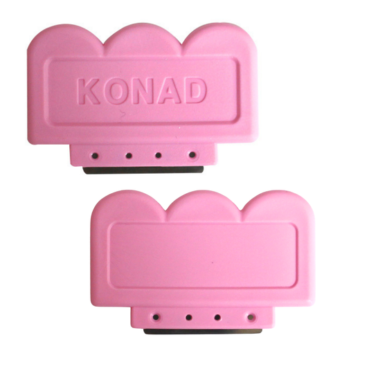 Two pink plastic Konad nail art stamping scrapers with scalloped edges, one embossed with the brand name 'KONAD' and one blank, shown on a white background.