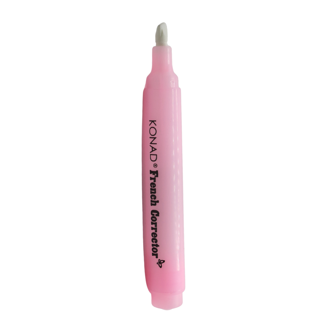 A pink Konad Nail Polish Corrector pen with black text printed on the barrel, shown vertically against a plain white background.