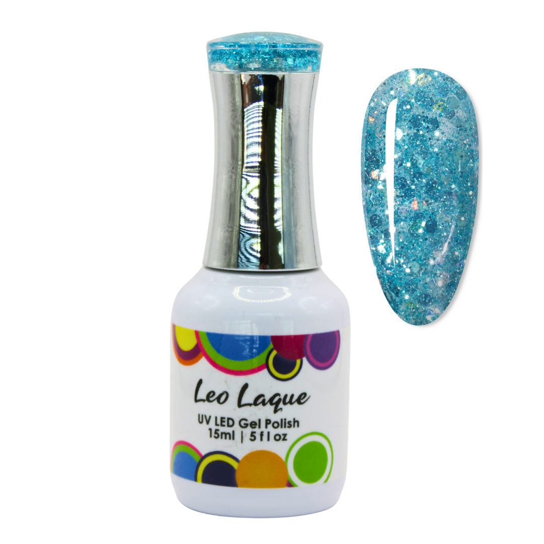 A bottle of Leo Laque UV LED gel nail polish with a silver cap and a white label, shown next to a nail tip swatch displaying the sparkling light blue glitter polish.