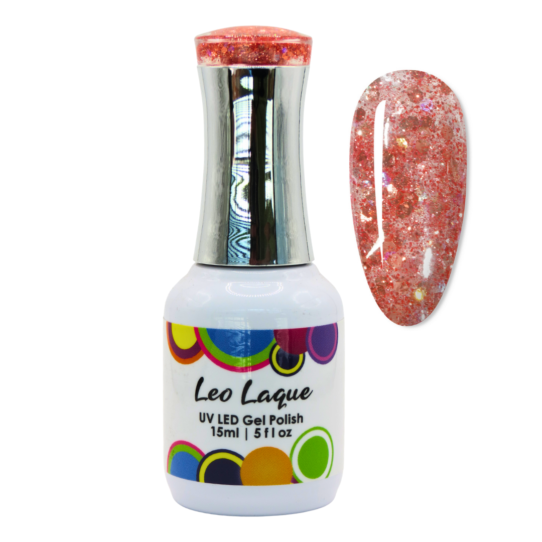 A bottle of Leo Laque UV LED Gel Polish with a silver cap and a white label, shown next to a nail swatch displaying a sparkling coral-pink glitter polish.