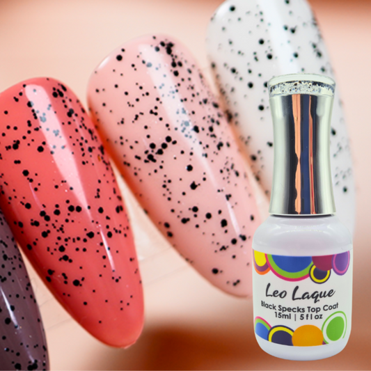 A bottle of Leo Laque Black Specks Top Coat nail polish shown in front of several artificial nails swatched with the product, featuring black speckles over pink, white, coral, and purple bases.