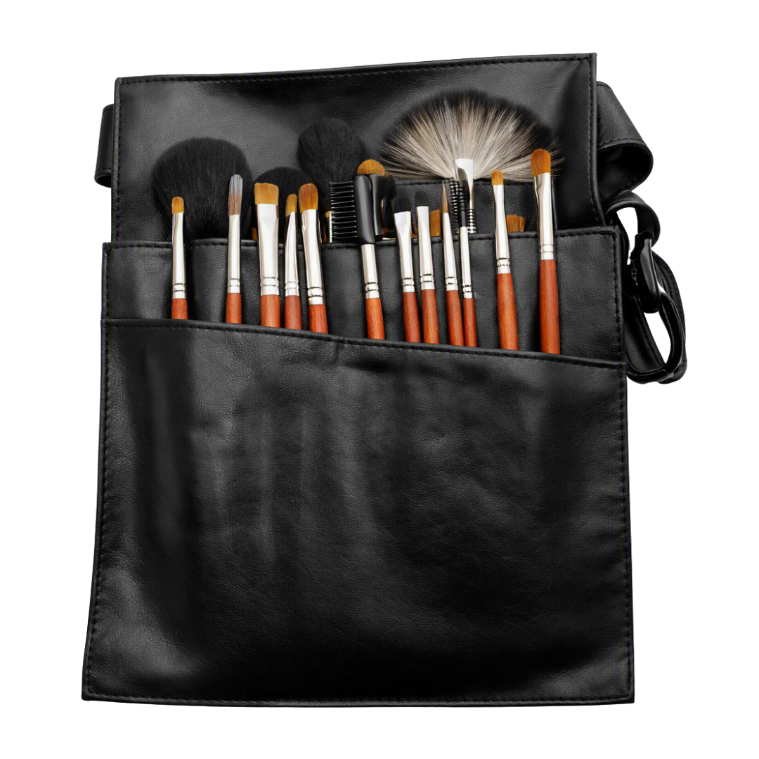A black faux-leather makeup brush case with multiple compartments holding a set of makeup brushes. The brushes have orange handles, silver ferrules, and white bristles, and the case has a black shoulder strap, shown on a plain white background.