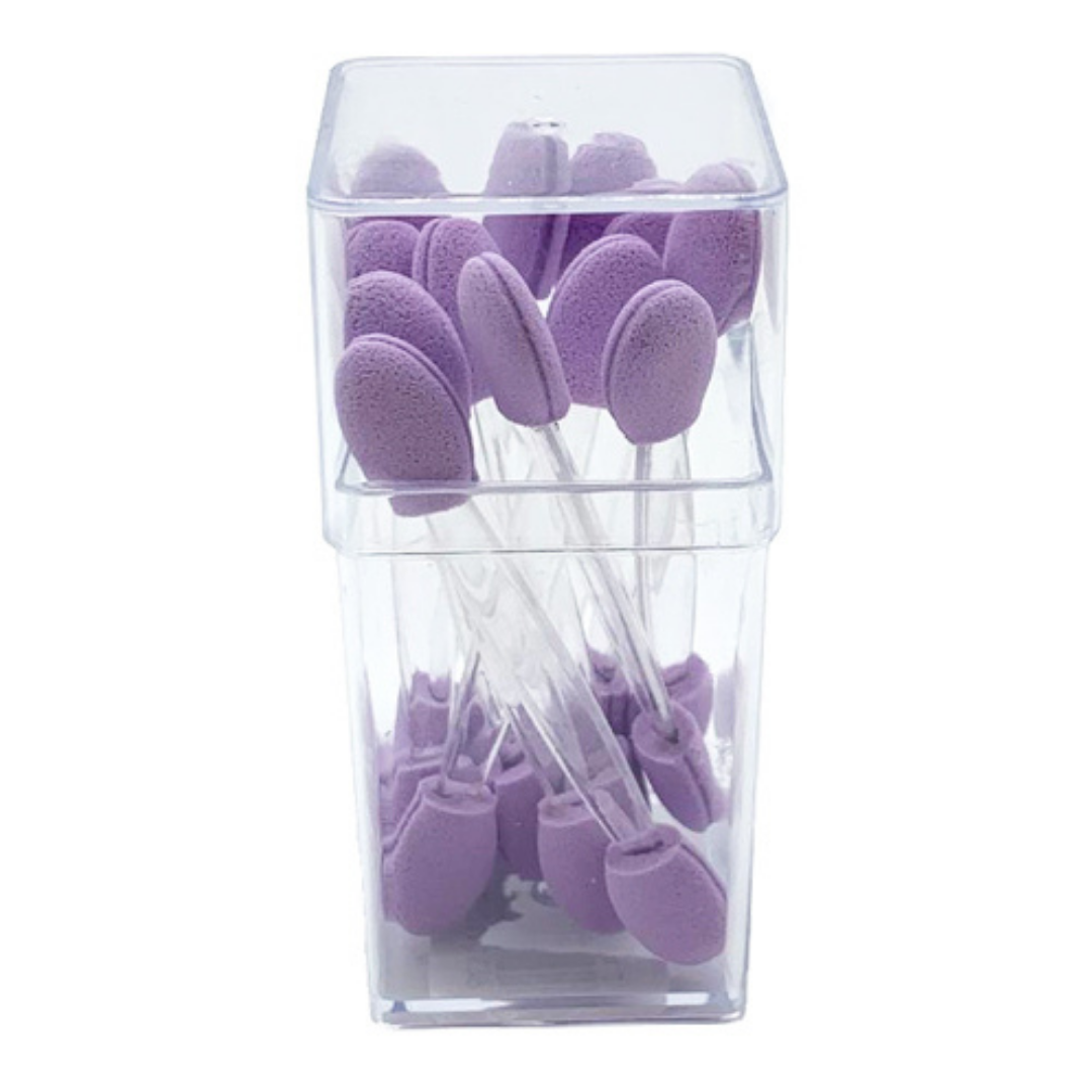 A clear plastic container holding multiple purple oval-shaped applicator pads on clear plastic handles, isolated on a white background.