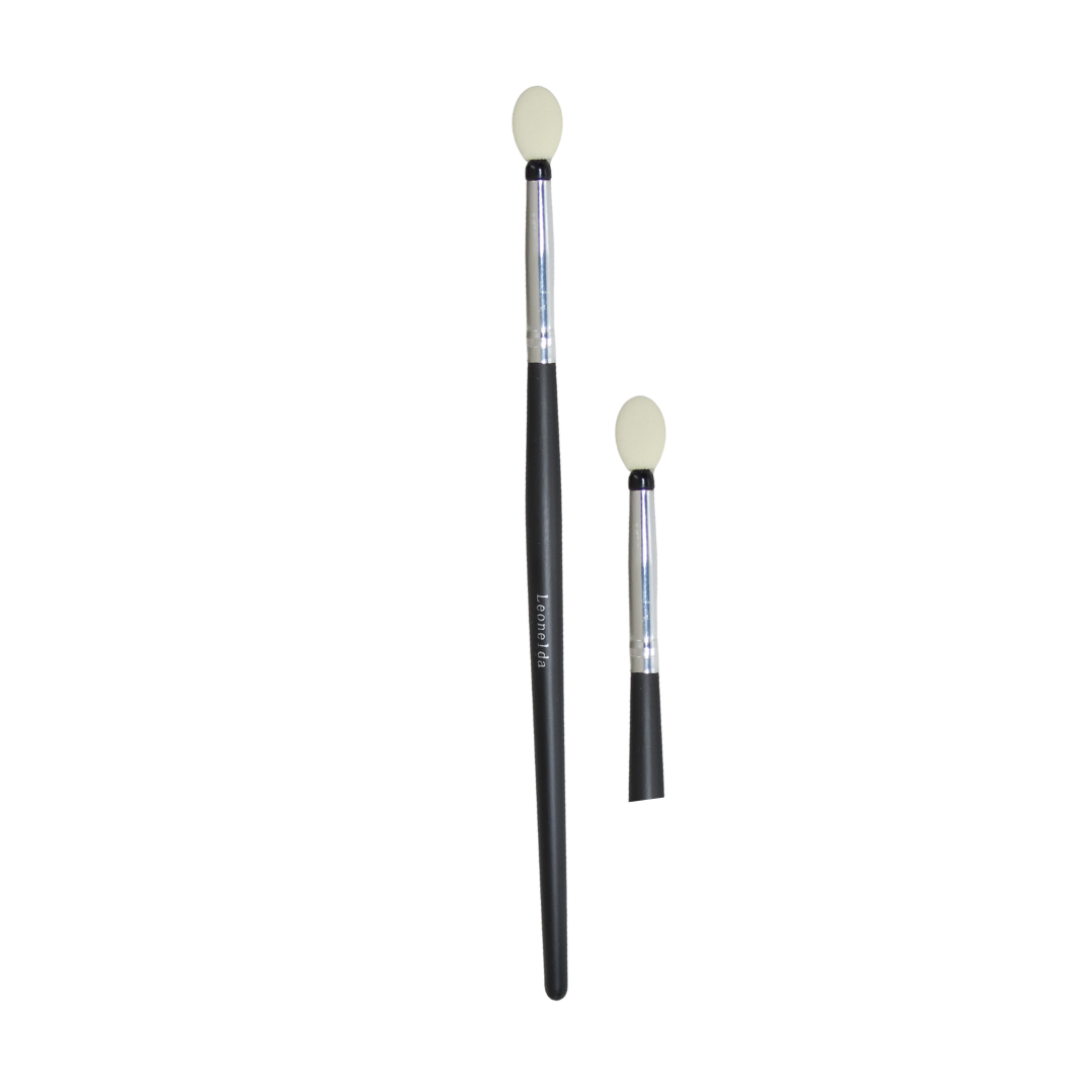 Two makeup brushes with black handles, silver ferrules, and cream-colored oval bristles, shown on a plain white background.