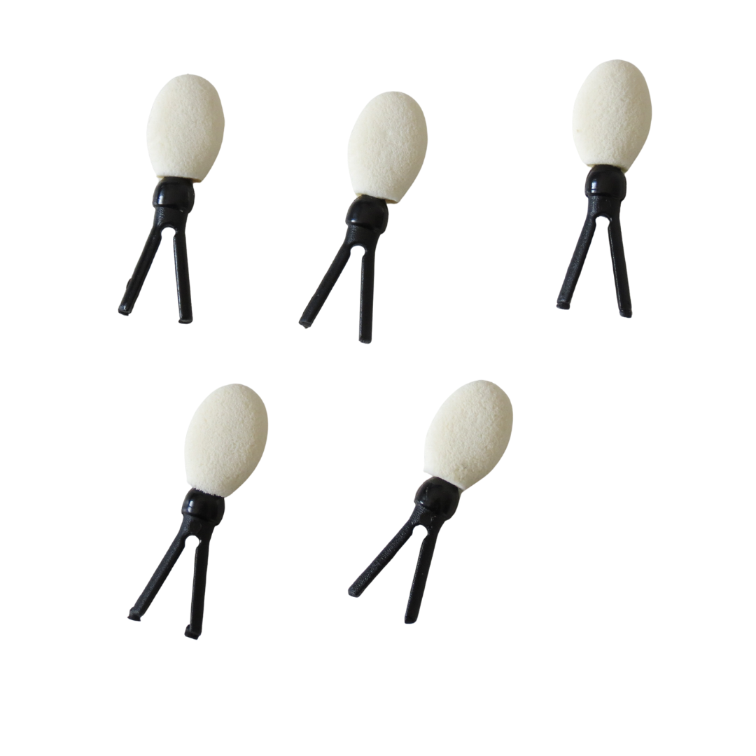 Five small eyeshadow sponge applicator refills for brush with oval off-white heads and black tripod-like bases, arranged on a plain white background.