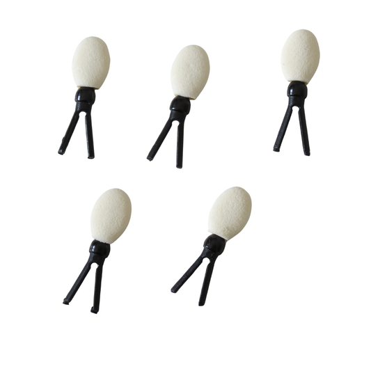 Five small eyeshadow sponge applicator refills for brush with oval off-white heads and black tripod-like bases, arranged on a plain white background.