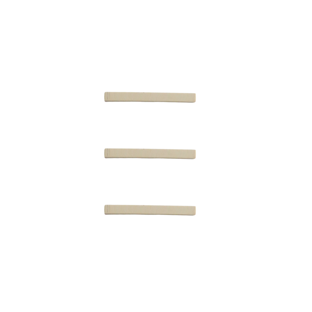 Three long narrow rubber eyelash curler replacement strips on white background
