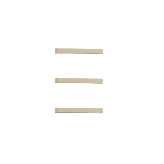 Three long narrow rubber eyelash curler replacement strips on white background