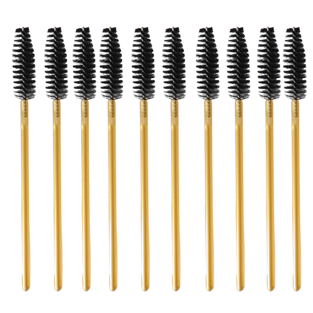 Ten gold spoolie-style eyebrow brushes with black bristles, arranged in a row on a plain white background.