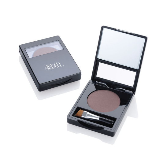 A black rectangular makeup compact shown open and closed on a white background. The open compact reveals a round pressed eyebrow powder in a muted medium-brown shade, a mirror in the lid, and a small applicator brush resting inside. Ardell branded.