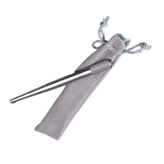 A silver metal micro blading tool with a knurled grip, shown alongside a light gray drawstring pouch on a plain white background.