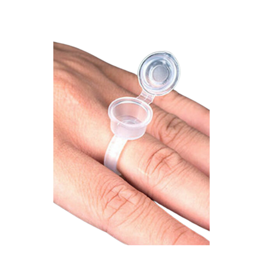 A small clear plastic sample vial ring with an attached flip-up cap, shown worn on a person's finger against a plain white background.