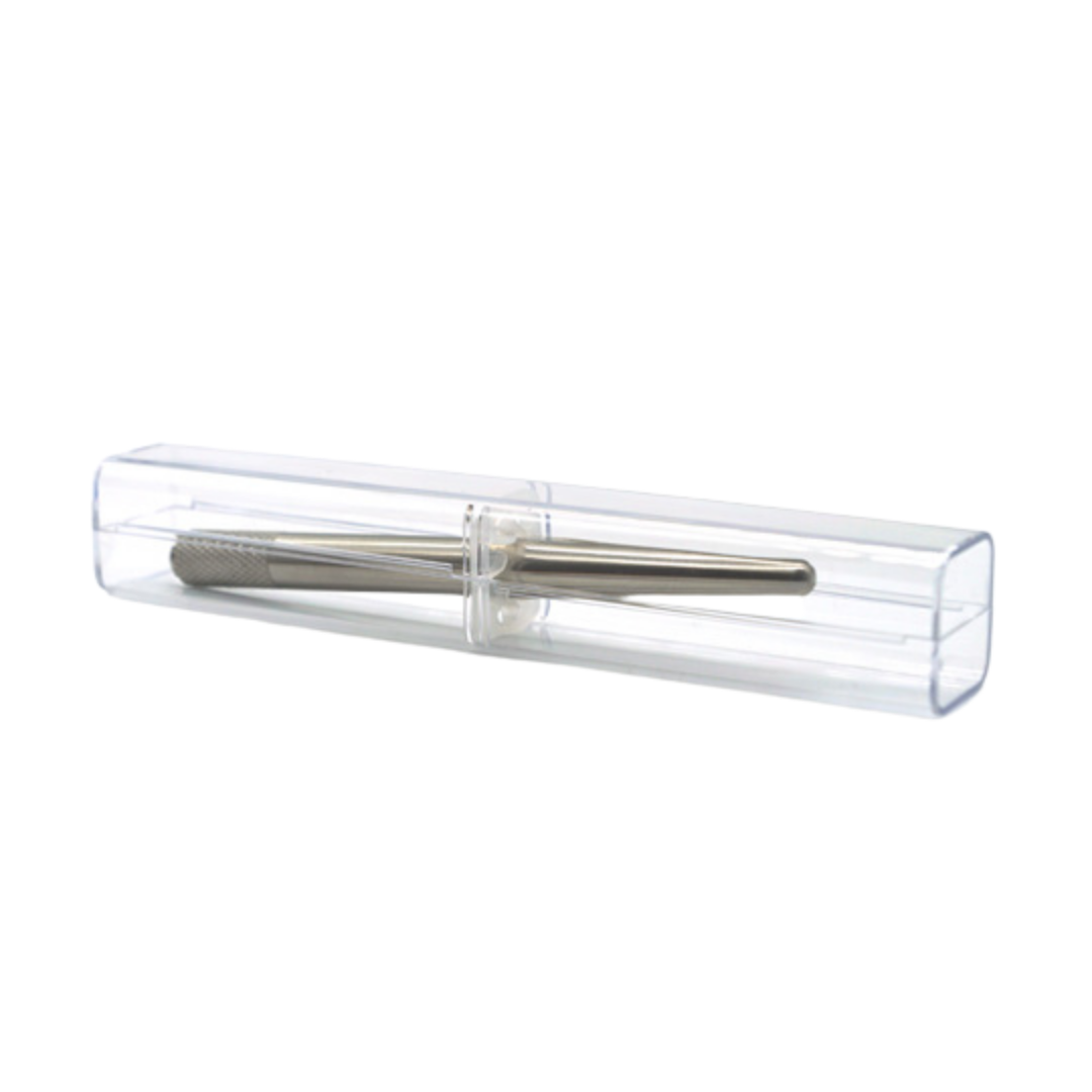 A silver metal microblading tool enclosed in a clear plastic protective case, shown against a plain white background.