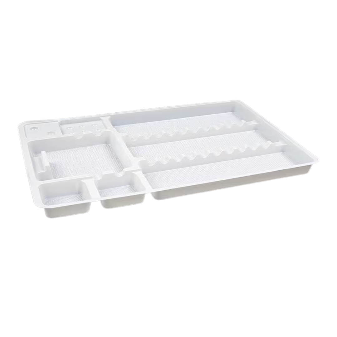 A white plastic organizer tray with multiple compartments, including one wavy-edged slot and several small cubbies, shown on a plain white background.