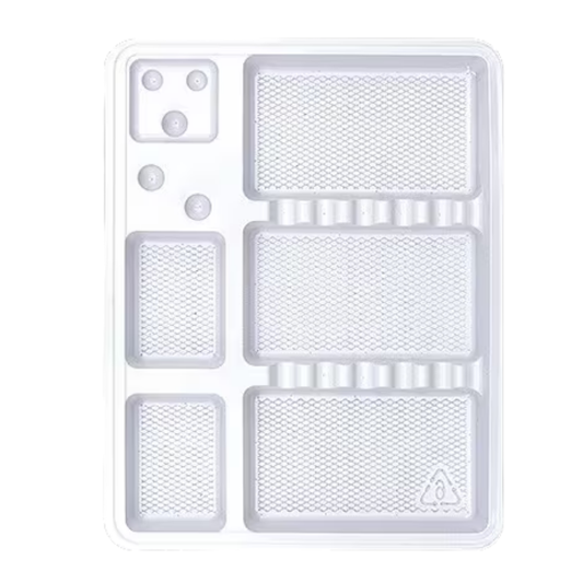 A clear plastic multi-compartment tray with textured rectangular sections, circular inserts, and a small triangular symbol near the bottom right, shown on a white background.