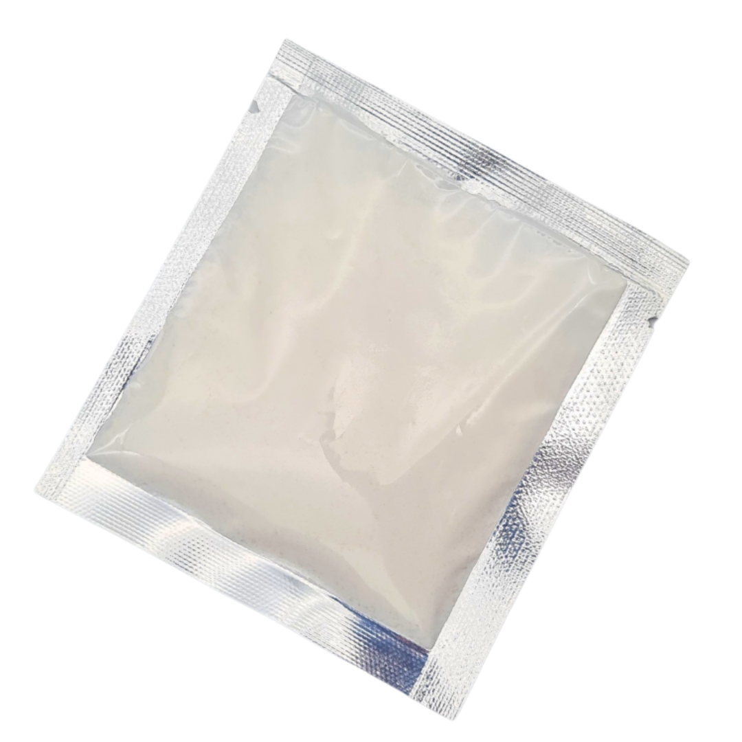 A square silver foil resealable pouch containing a translucent off-white foot soak powder shown on a plain white background.