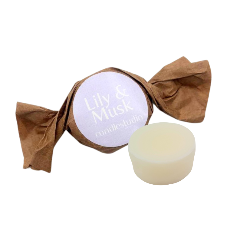 Wax Melt wrapped in brown paper with a visible brand label on a white background