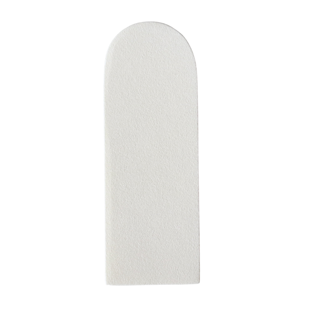 Disposable white grit pad for stainless steel foot file on a white background