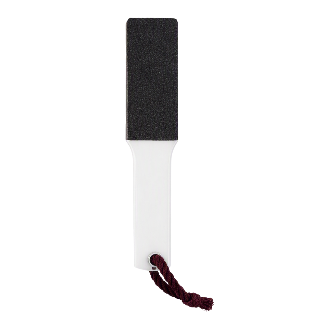 A rectangular black and white foot file with a dark red hanging cord, shown against a plain white background.