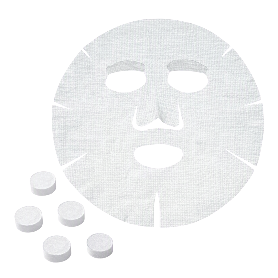 A white facial sheet mask with cutouts for the eyes, nose, and mouth, shown on a plain white background with five small round white compressed masks placed in the lower left.