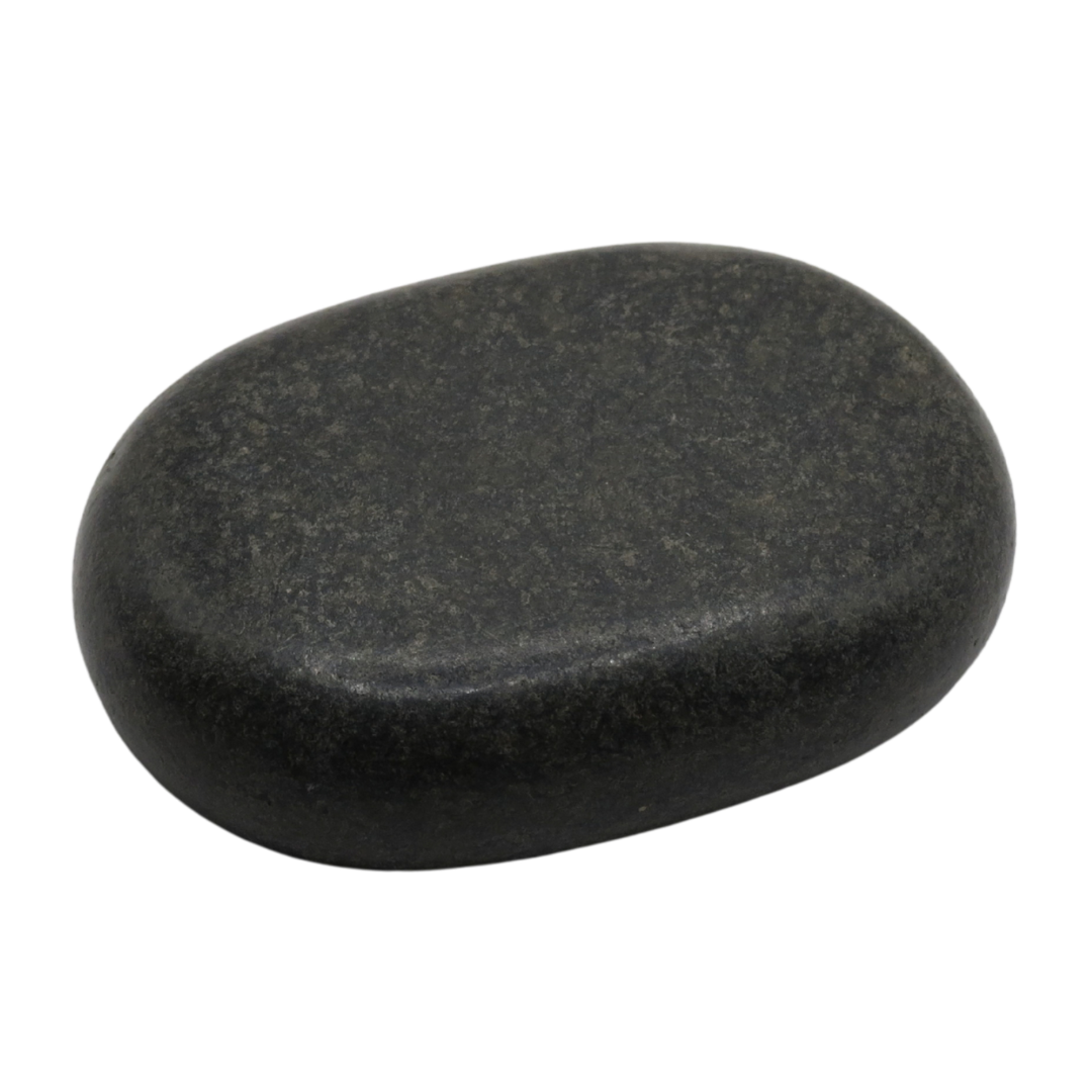 Smooth black spa hot stone on a plain white background.