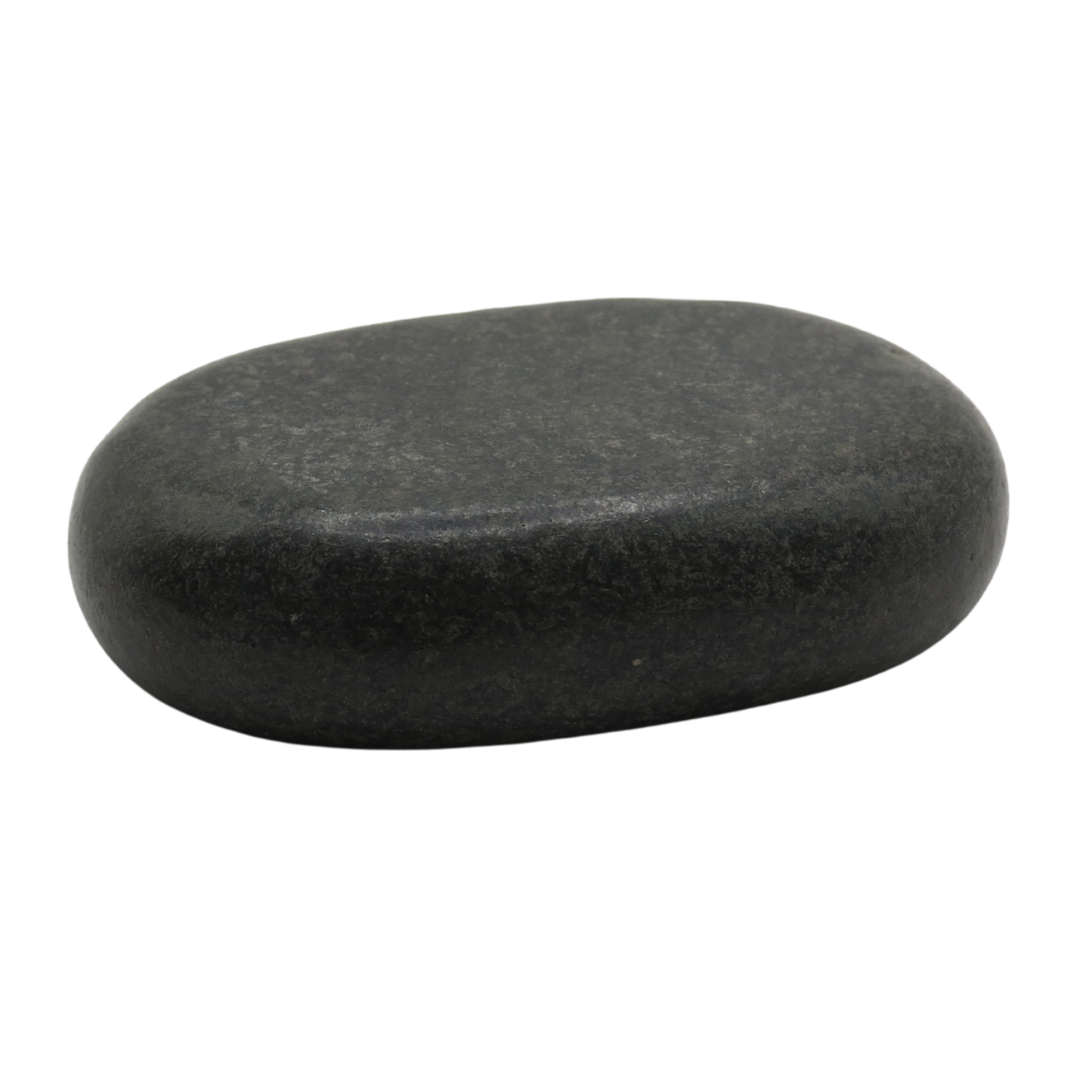 Smooth black spa hot stone on a plain white background.