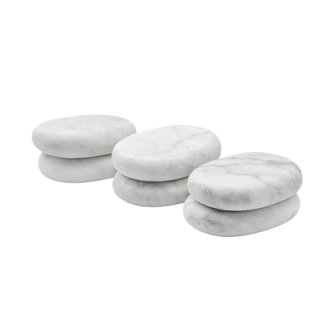 Six round white marble spa massage stones with natural gray veining, stacked in pairs on a solid white background.